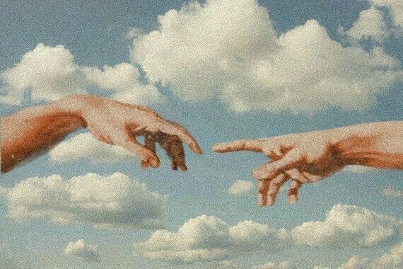 Two hands reaching toward each other against a sky of clouds